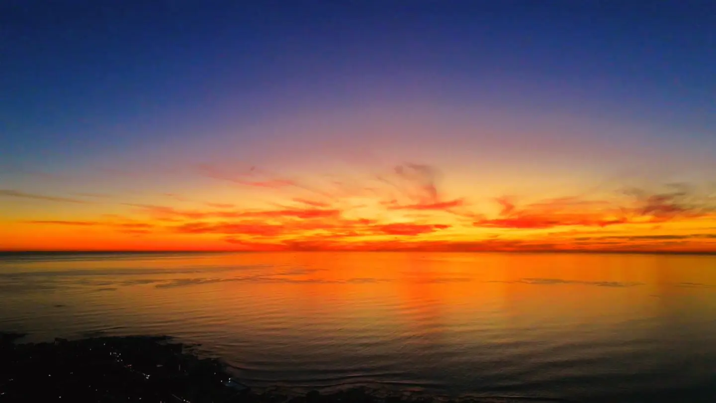 Ocean under a fiery sunset sky